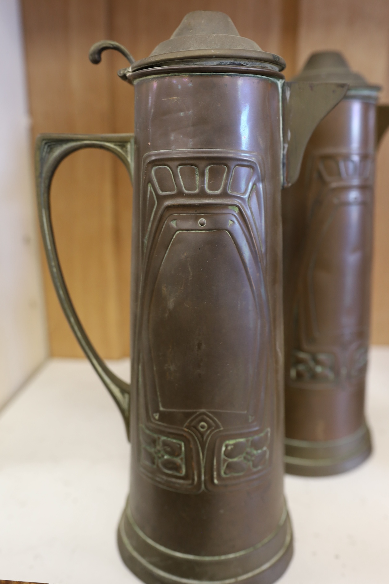 Three Art Nouveau mixed copper and brass coffee pots and two individual copper filter coffee glasses, tallest 36cm high (5). Condition - two pots need cleaning, but good condition for age